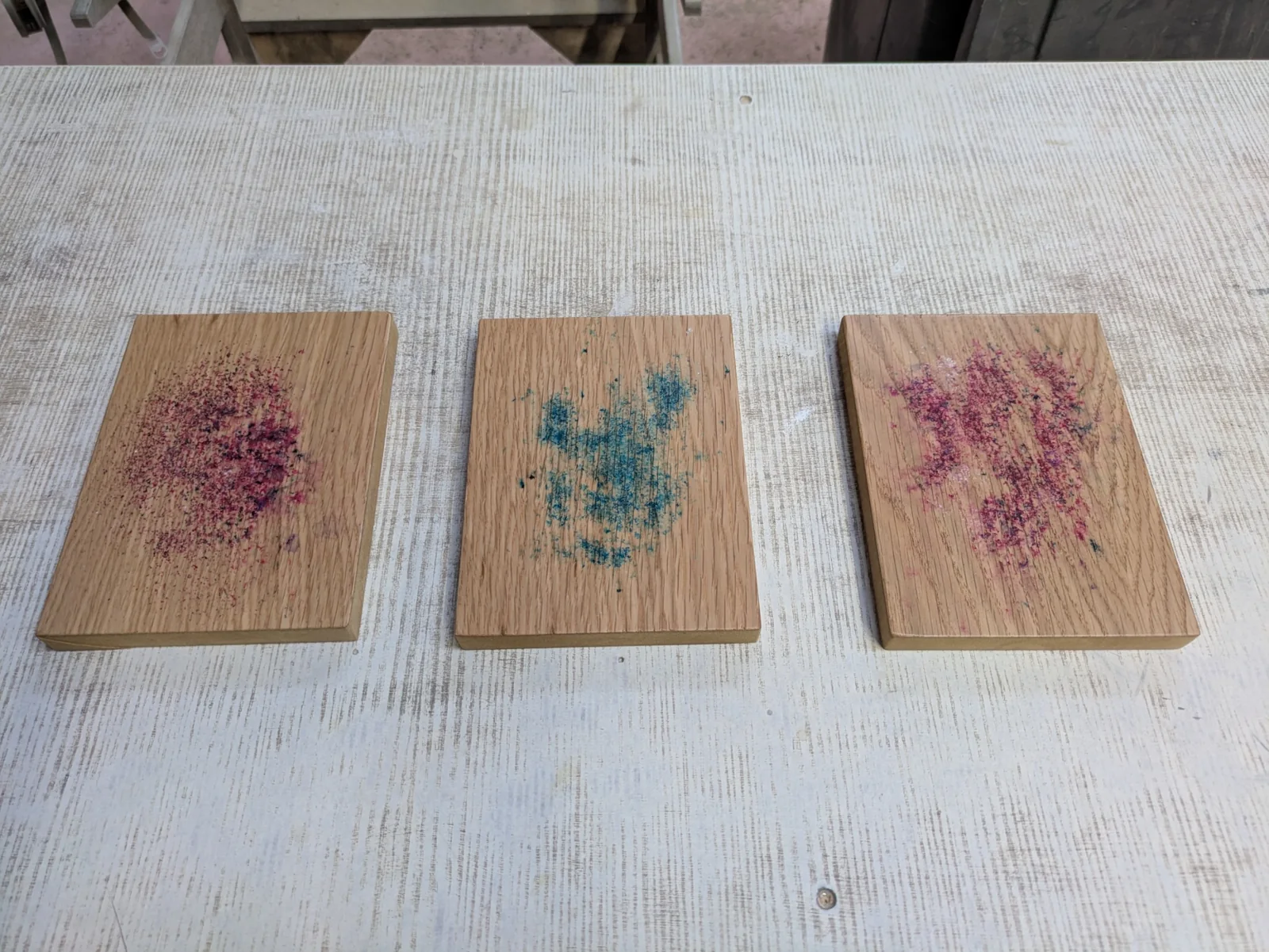 Three oak samples with pink and blue dye crystals
