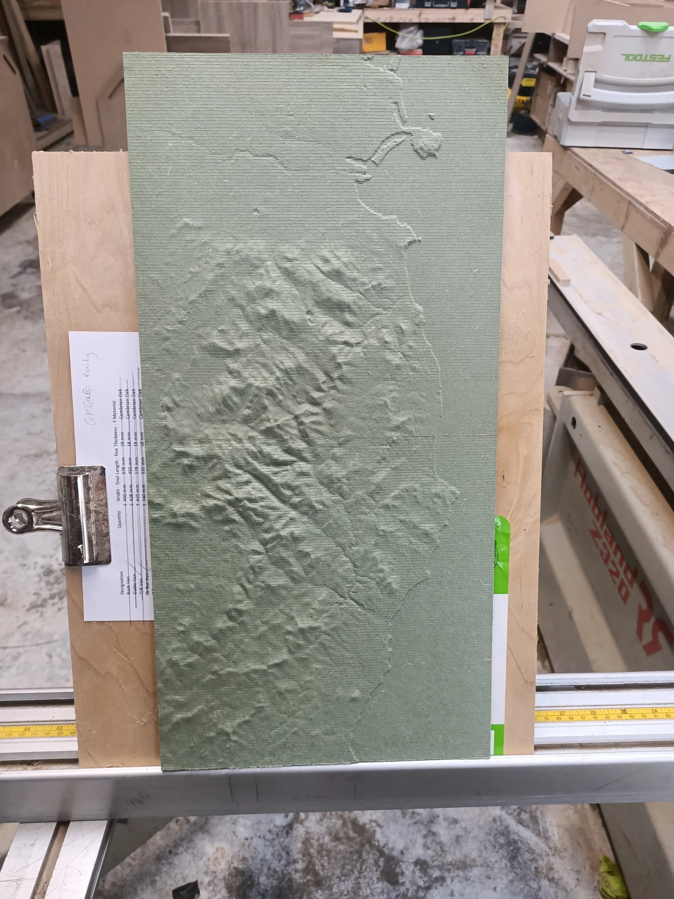 Early MDF tile alignment test held beside a straight edge