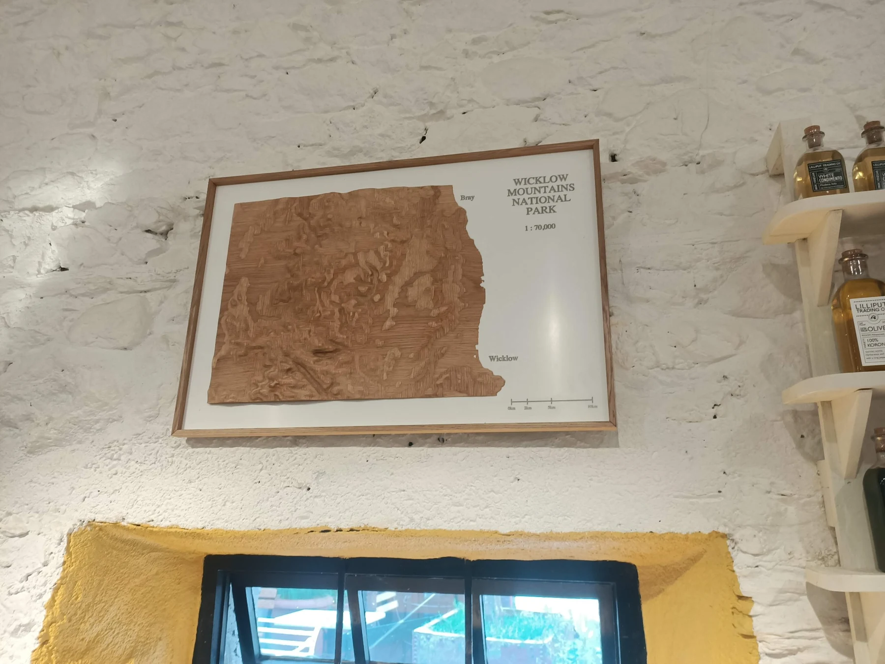 Oak veneer terrain model displayed on the wall at The Roundwood Stores café