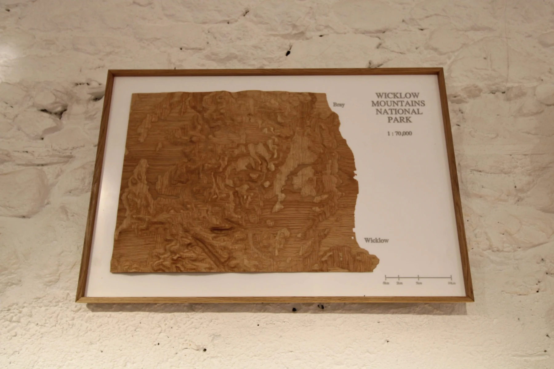 Framed oak veneer model of the Wicklow Mountains on a white acrylic background