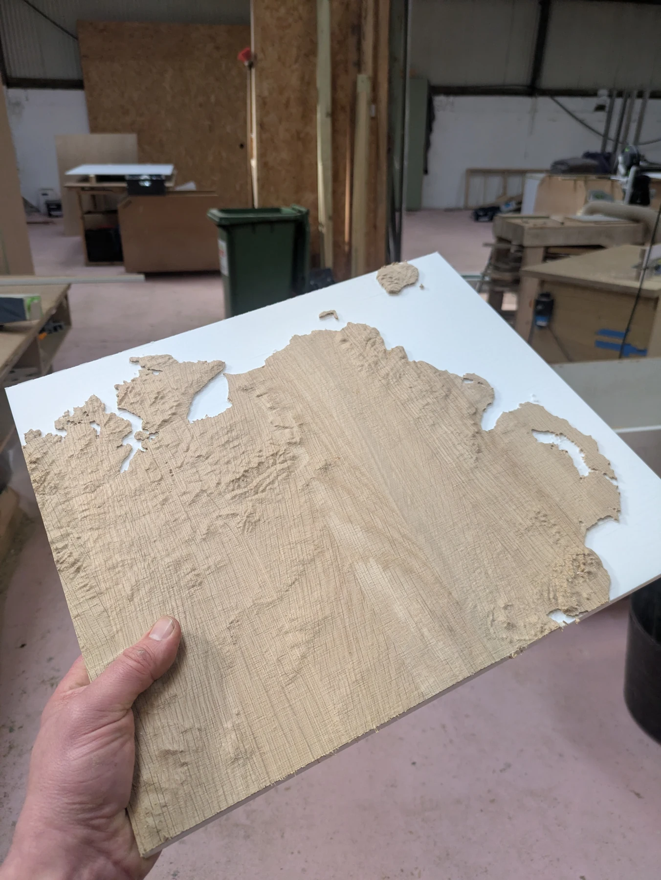 An oak terrain tile held up in the workshop