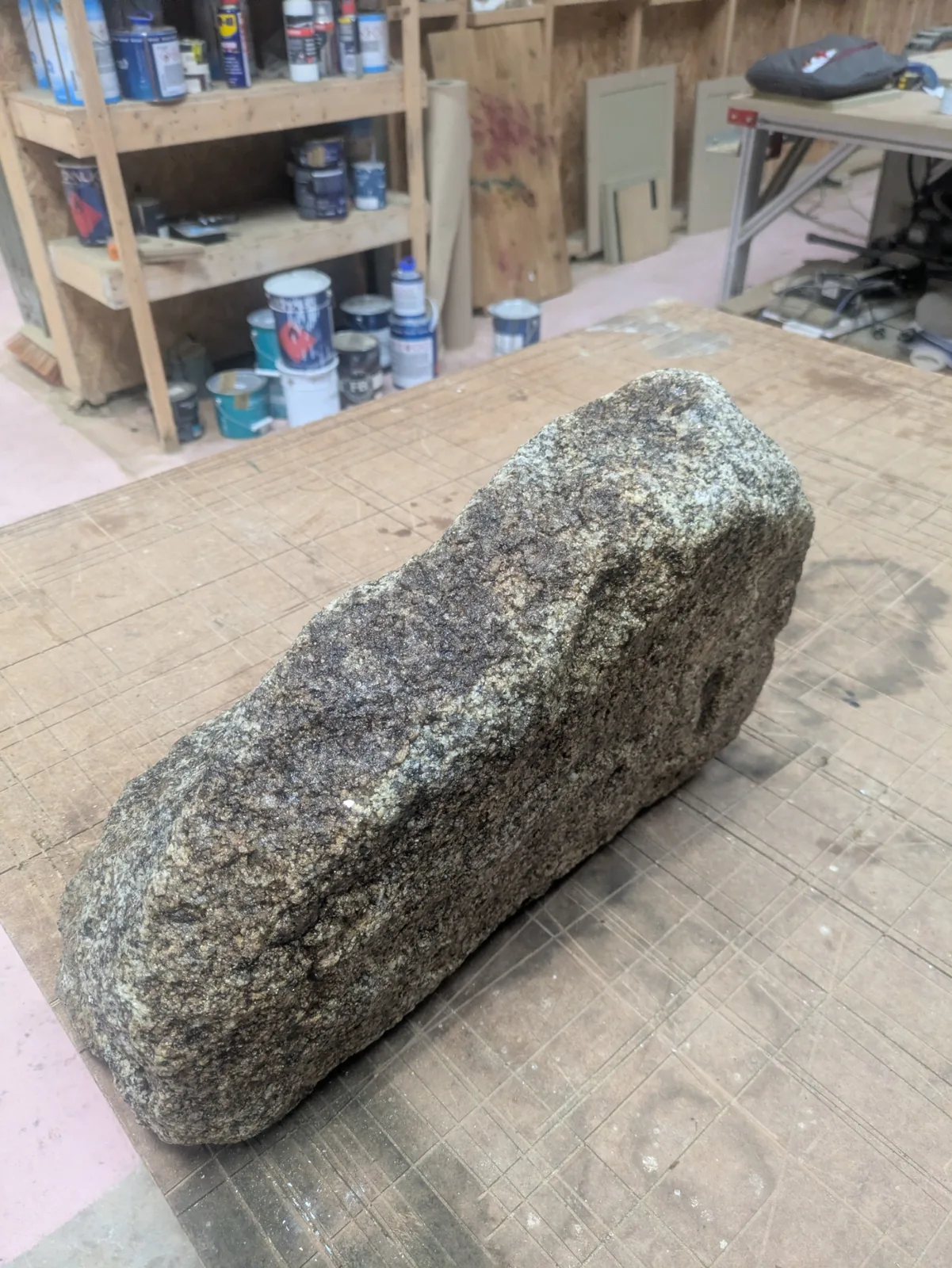 The long face of a cleaned granite stone on the workbench