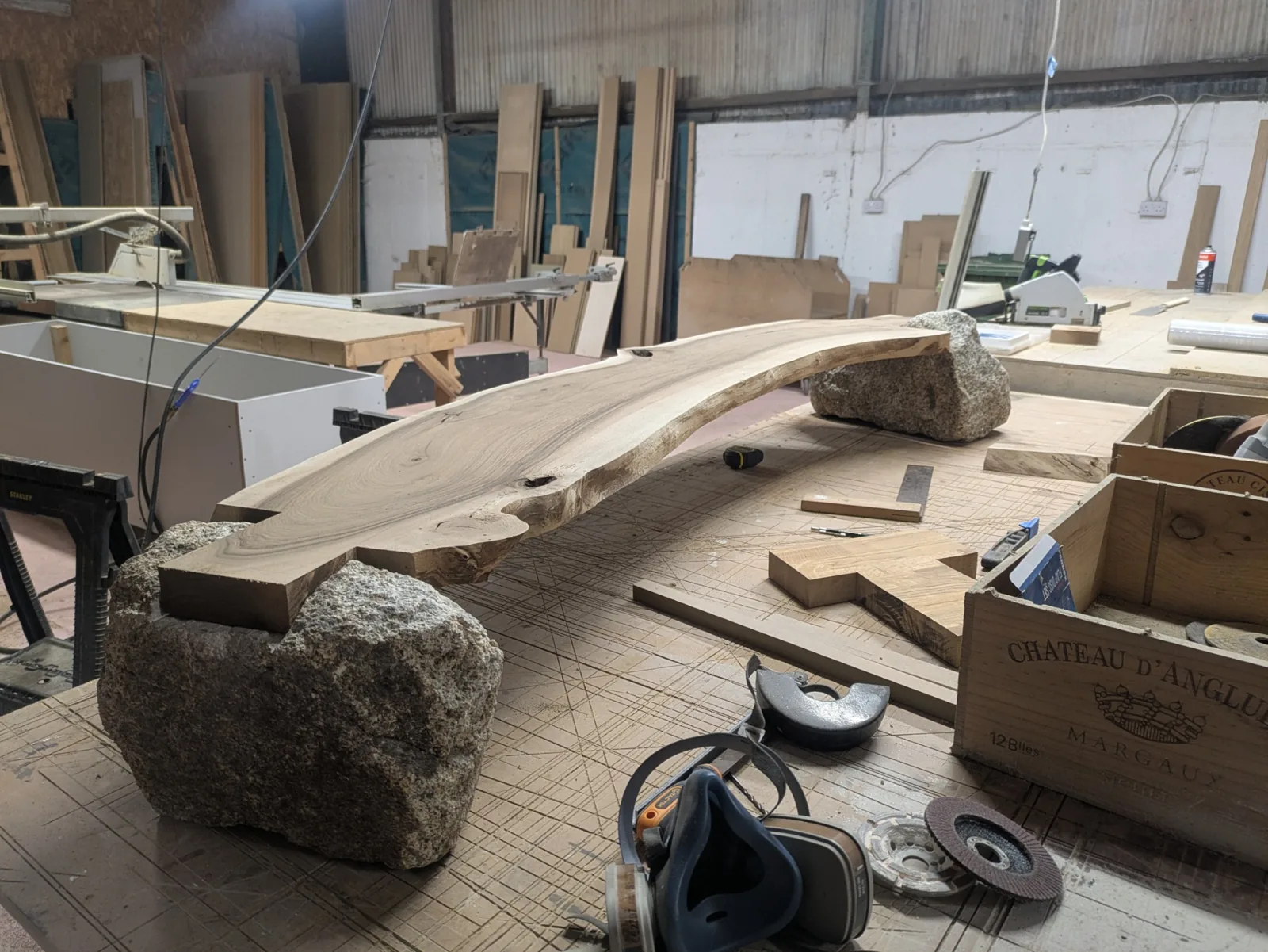 The walnut slab and granite supports brought together on the workbench