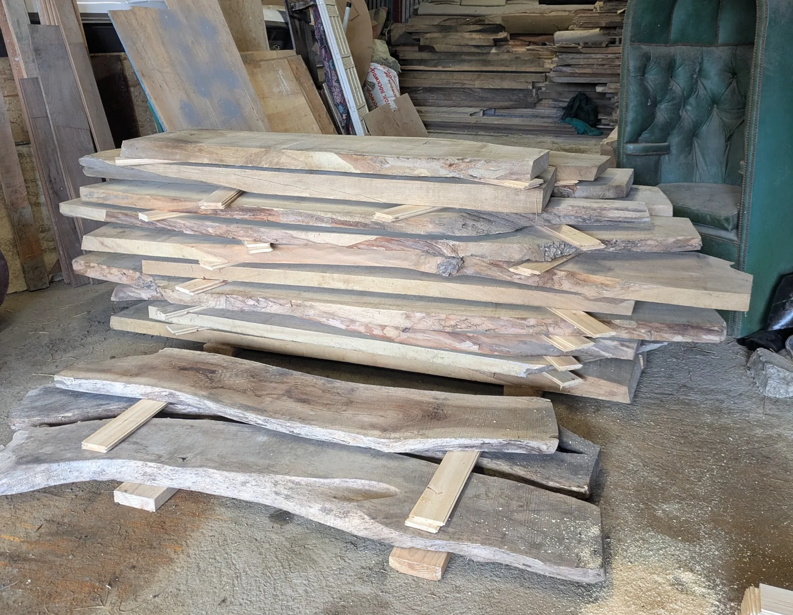 A stack of walnut slabs in the workshop